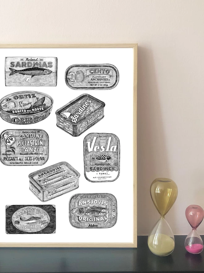Art print of hand drawn anchovy and sardine tins displayed in a frame