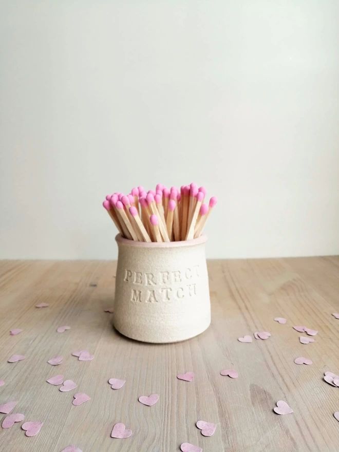 'perfect match' match pot with pink tip matches, small paper hearts scattered around the pot