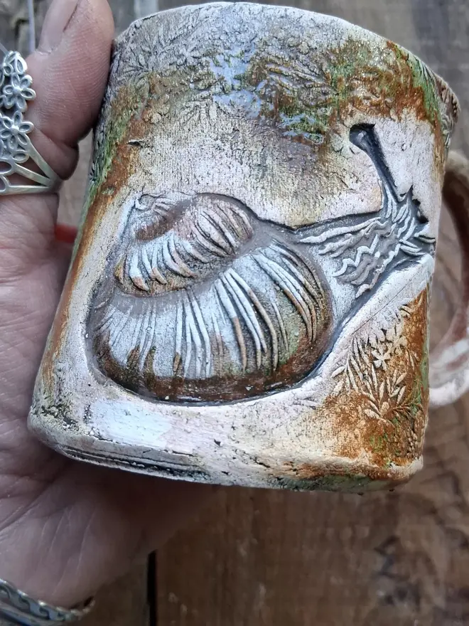 brian the snail stoneware mug. a brown mug linocut with an image of a garden snail.