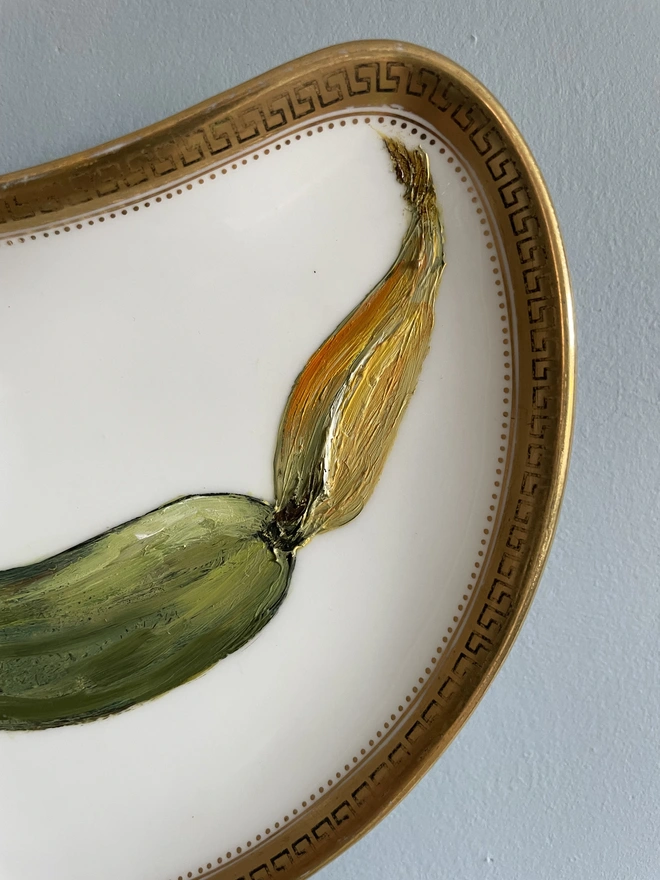 detail of courgette oil painting on plate