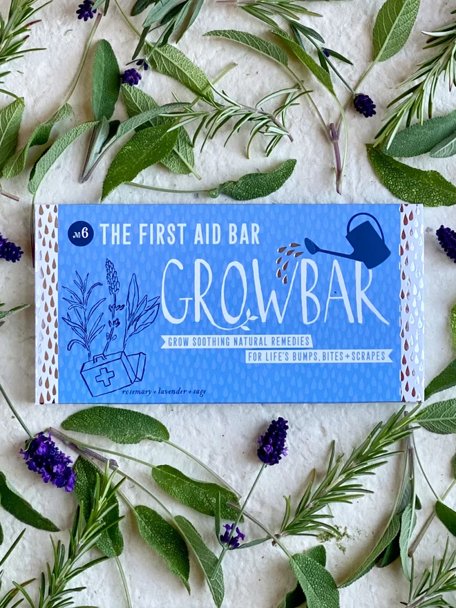 The Get Well Soon Growbar laying on a mixture of rosemary springs, sage leaves and lavender flowers.