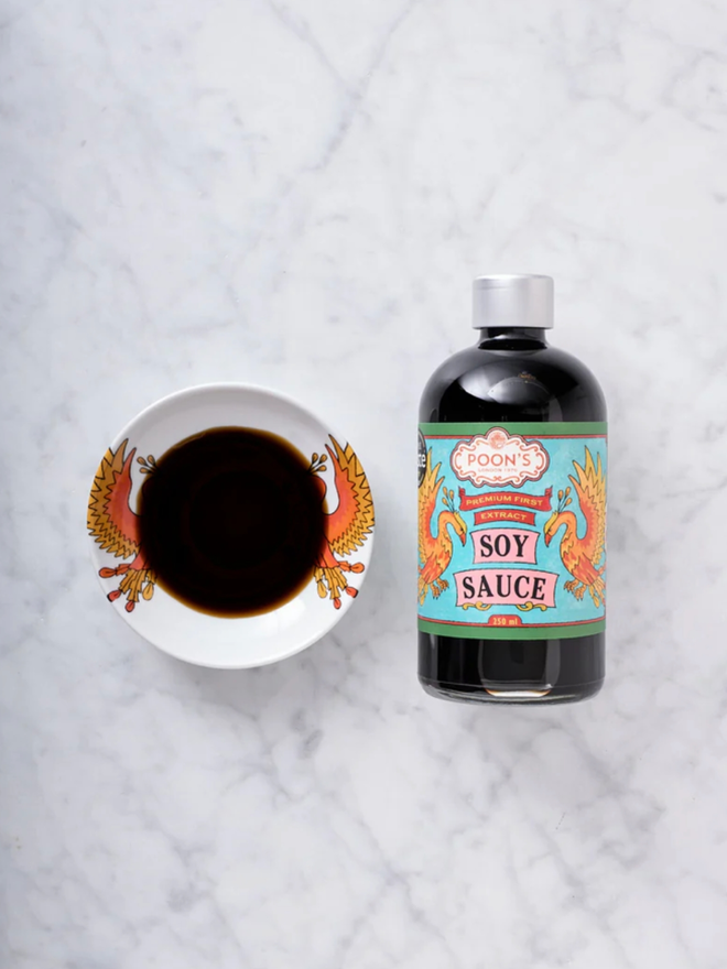 Premium Soy Sauce. A bottle of sauce with a sample in a dish.