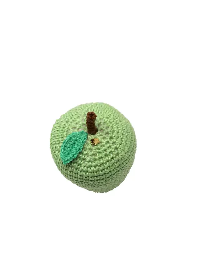 Cut out image of a green crochet apple with a plain background.