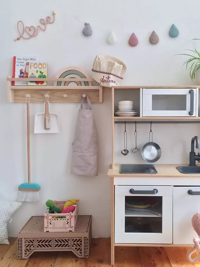 A beautiful handmade solid wood pegrail shelf. Kids storage for a playroom 