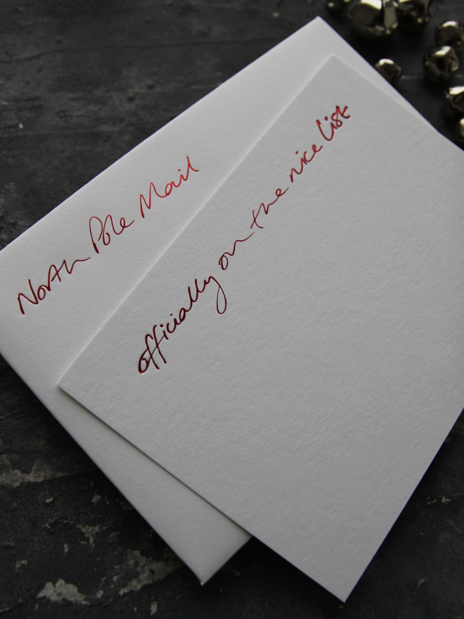christmas notecard form Santa that says Officially On The Nice List in red foil with an envelope that says North Pole Mail