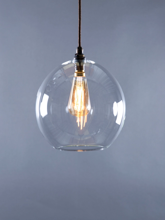 Medium Sized clear Glass Wanda Light with the light switched on