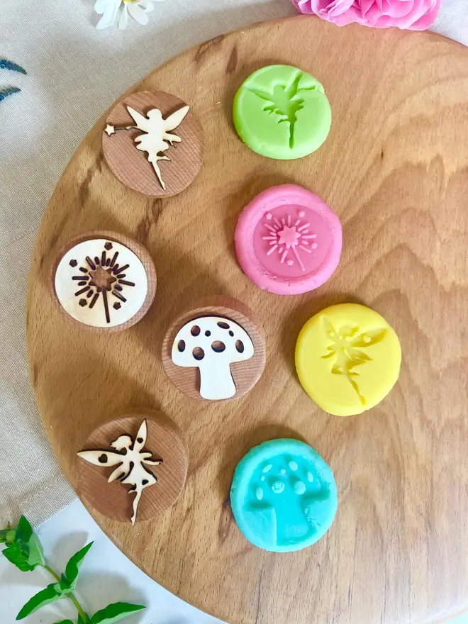 fairy sensory play dough sensory set. circles of play dough stamped with woodland shapes.