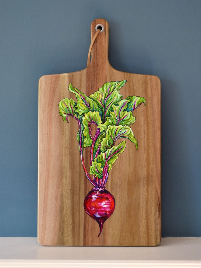 Wooden serving boards with a handpainted design of a beetroot