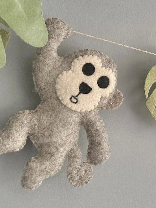 Nursery Safari Garland, a safari themed garland hanging in a child's bedroom against a grey backdrop. 