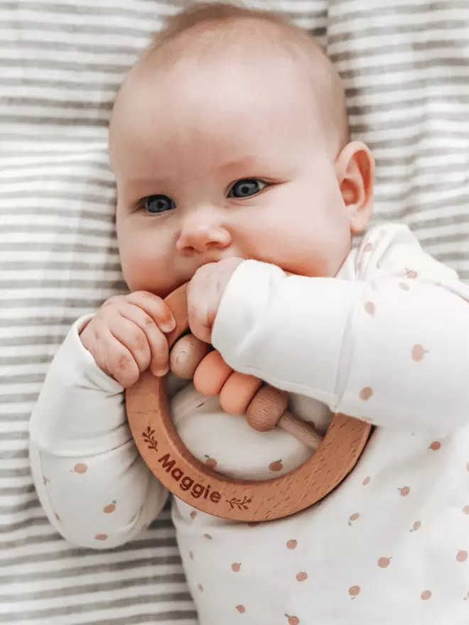 Baby with Wooden Ring Rattle