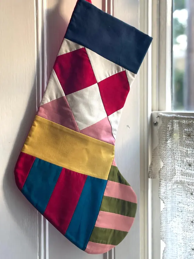 Pagliacci Patchwork Stocking, hanging.
