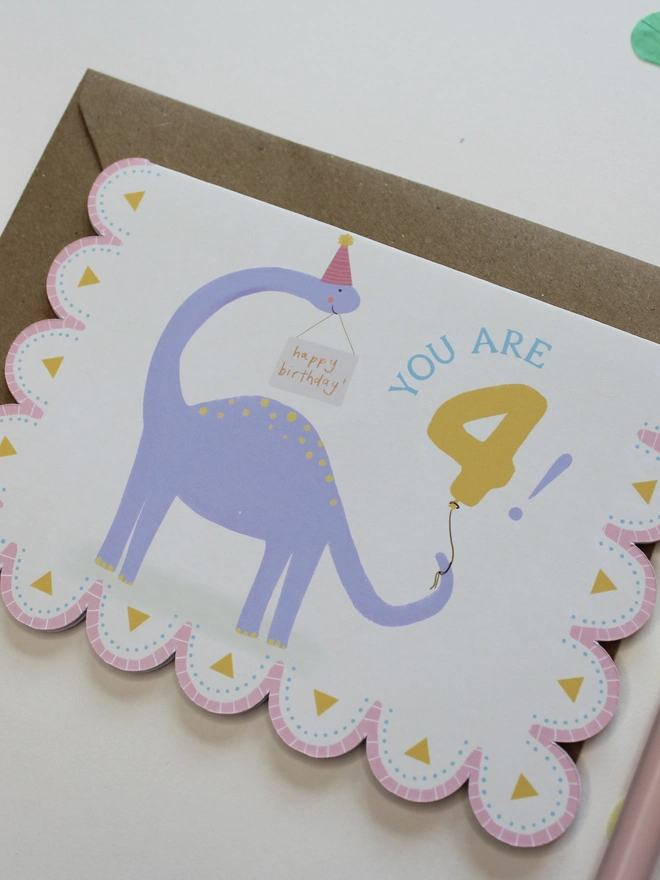 illustrated dinosaur 4th birthday card. scallop edged card 