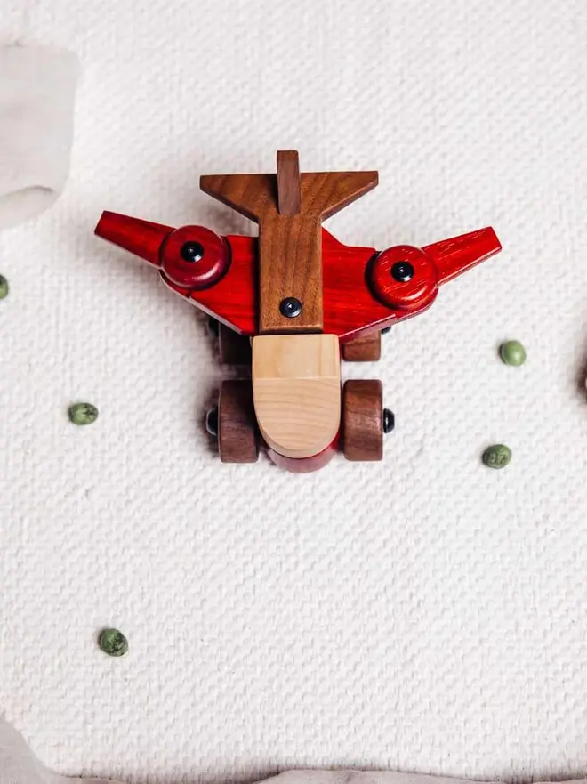 Walnut & Padauk Aeroplane Wood Heirloom Toy, on a table. 