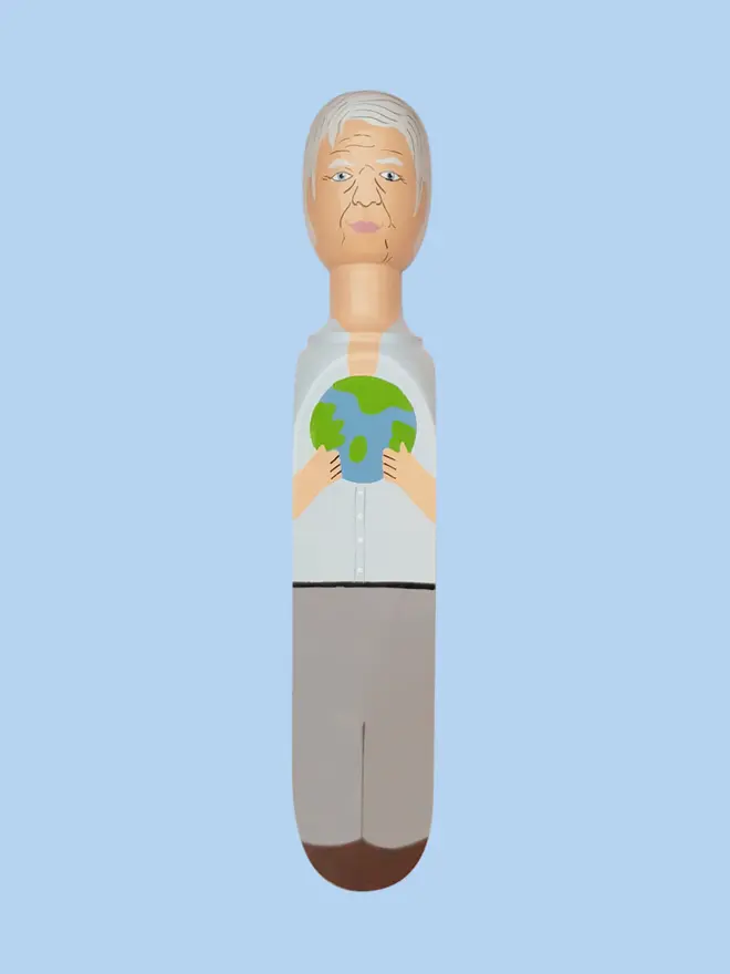 Wooden Door Stopper (Planet Dave), a colourful wooden door stop sitting on a white surface. 