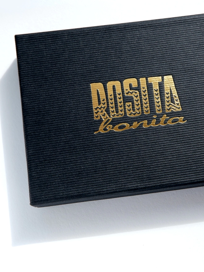 black cardboard box with Rosita Bonita Logo in Gold