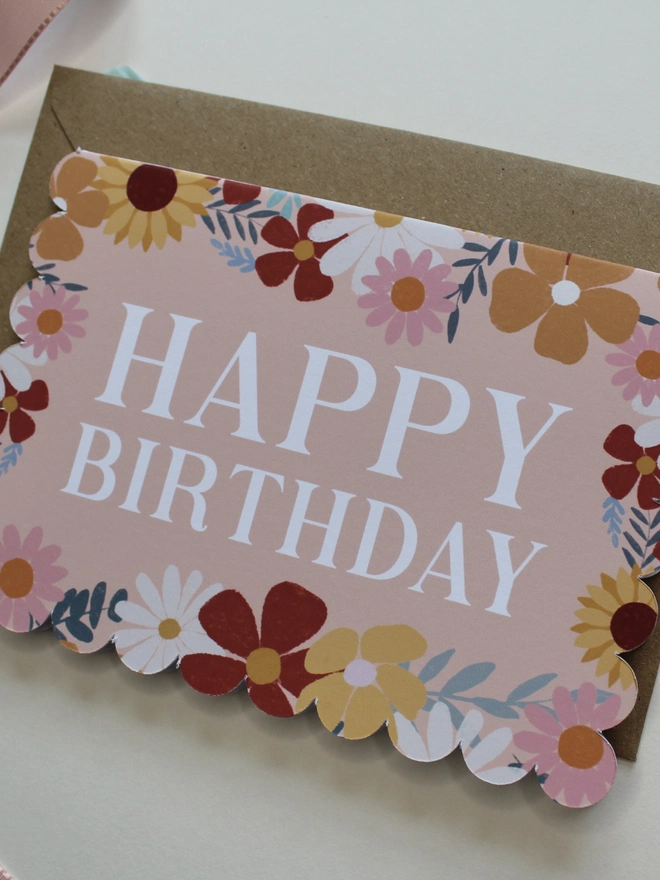 floral happy birthday card. scallop edged birthday card with illustrated flowers.