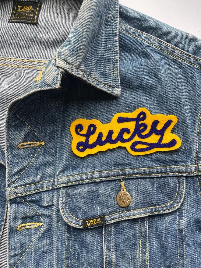 vintage chain stitched name patch in yellow and blue with the words Lucky