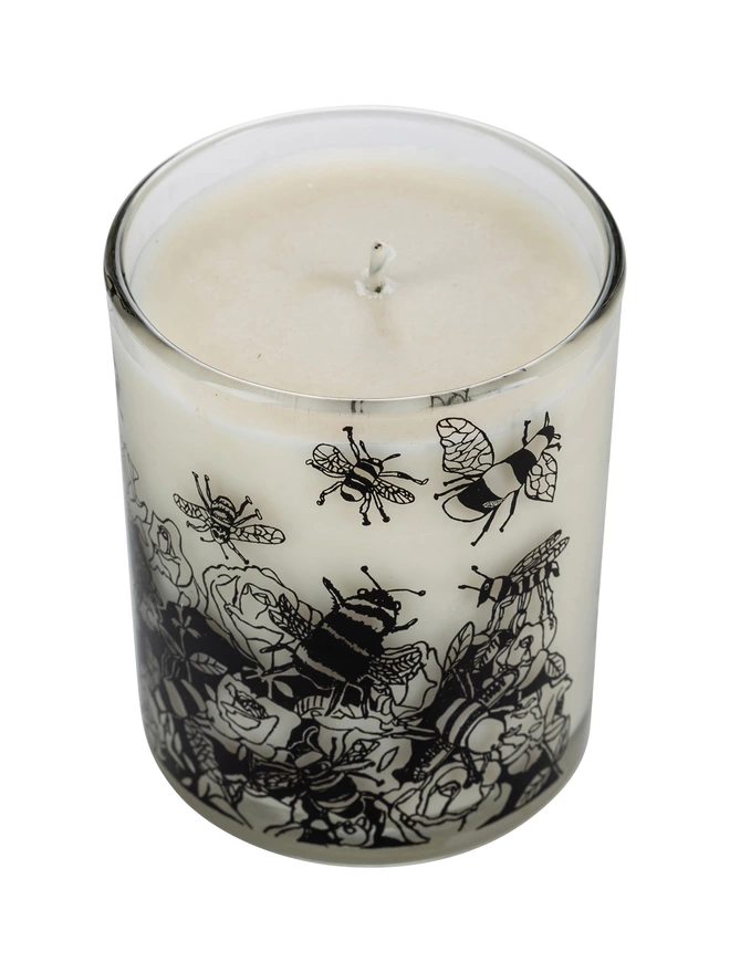 bee free oats & honey  charity candle in a reusable decorated glass with black illustrations