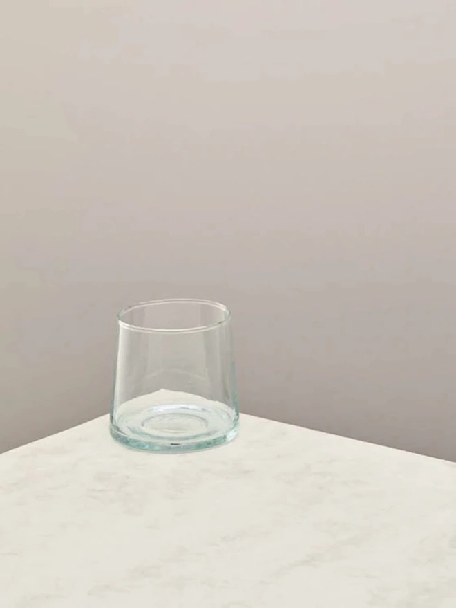 Whisky Glasses (Set Of 3), a whisky glass sitting on a plain counter top against a grey backdrop. 