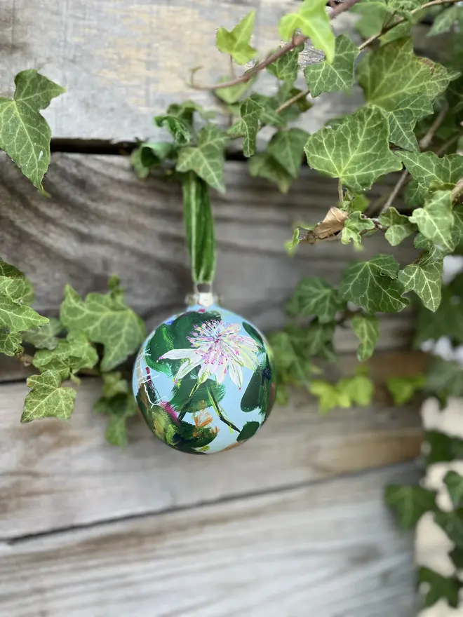 Unique hand-painted ceramic floral Christmas bauble featuring white astrantia flowers on a pale blue background