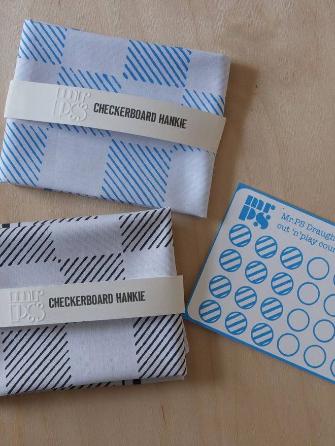 Mr.PS folded and packed Checkerboard hankies alongside a cut-out counter card