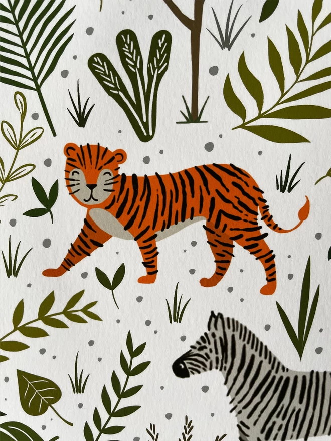 Close up of safari animal print featuring tiger, zebra and jungle leaves