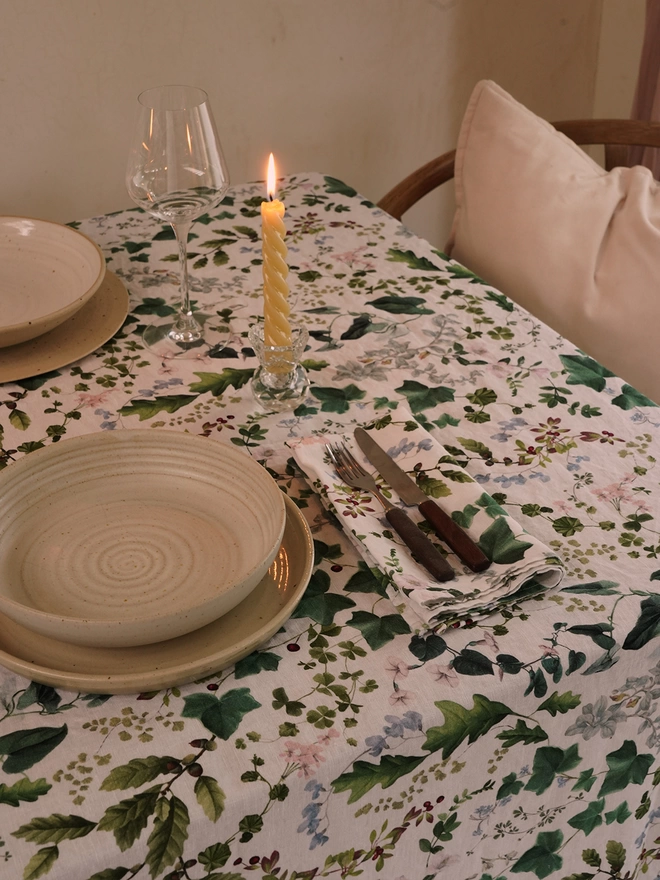Table laid with linens printed with leaves and flowers