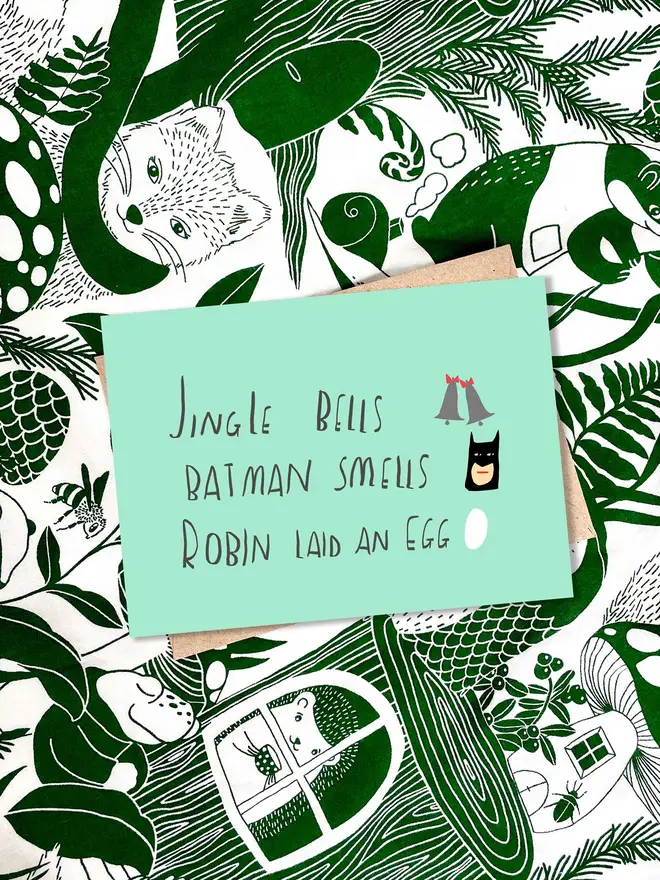 Card reads 'JINGLE BELLS BATMAN SMELLS ROBIN LAID AN EGG'