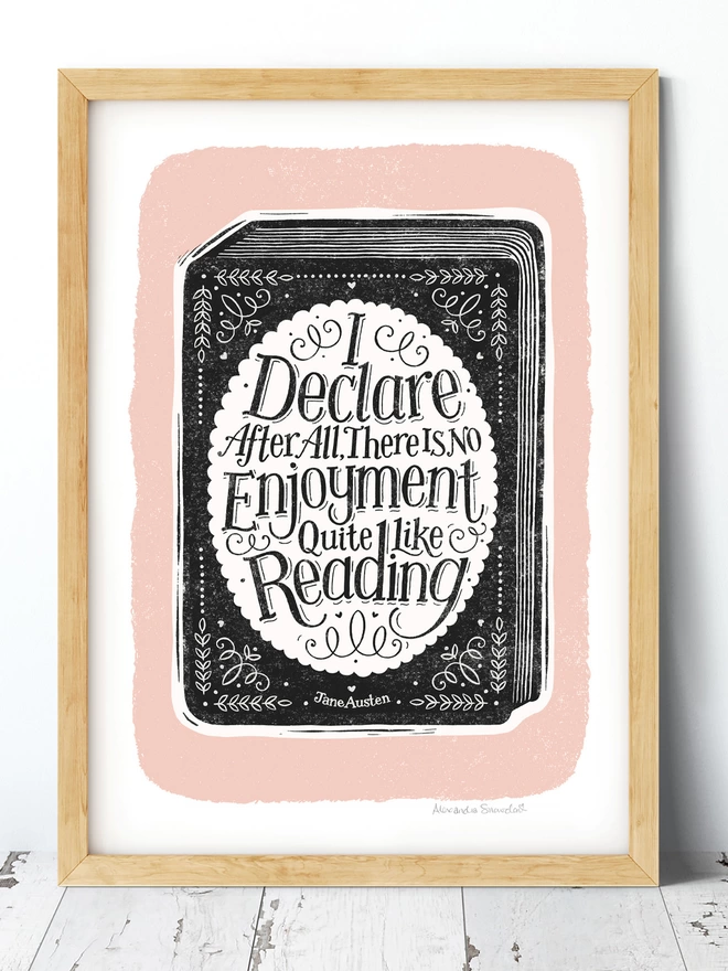 black white and pink reading quote print in a wood frame