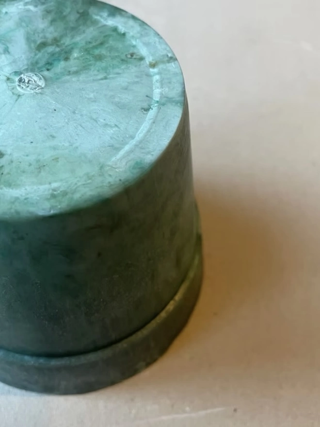 Small Green Ocean Plastic Plant Pot, a green recycled plant pot against a plain backdrop. 