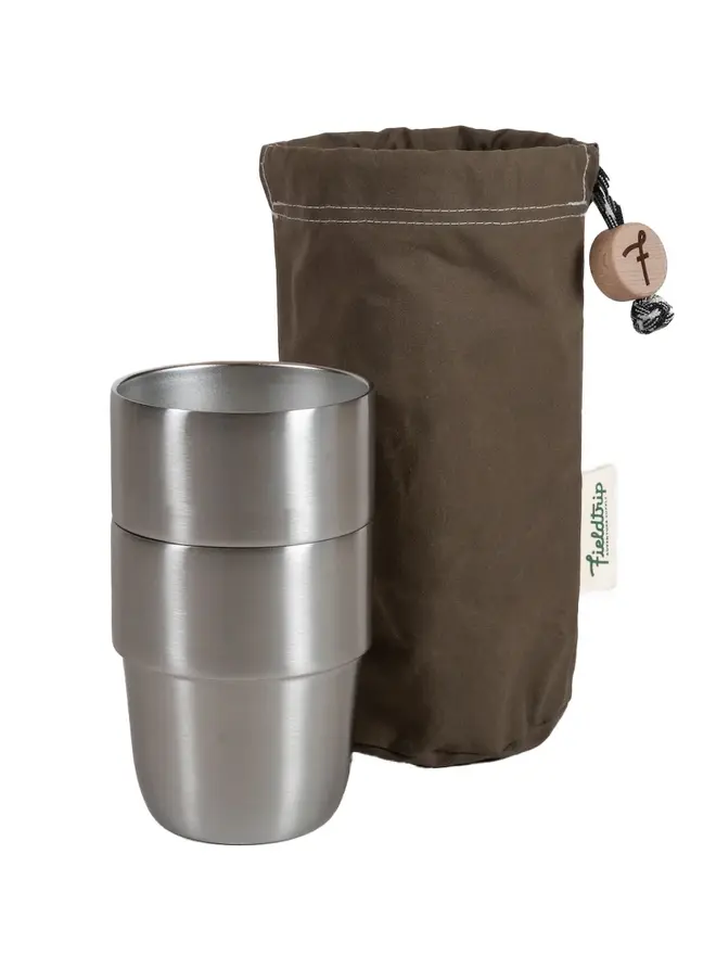 2 stainless steel cups next to an olive storage bag