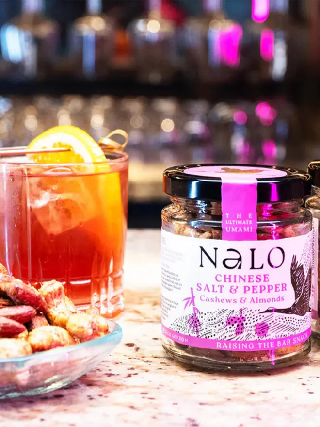 Chinese Salt & Pepper Cashews & Almonds (Set Of 6), displayed next to a cocktail. 