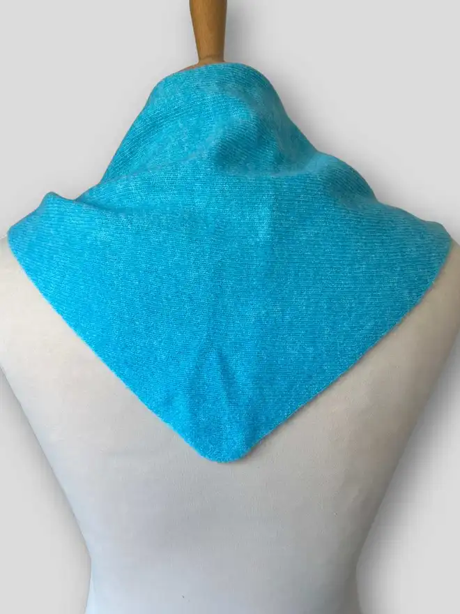 Turquoise triangle scarf shown from back on mannequin