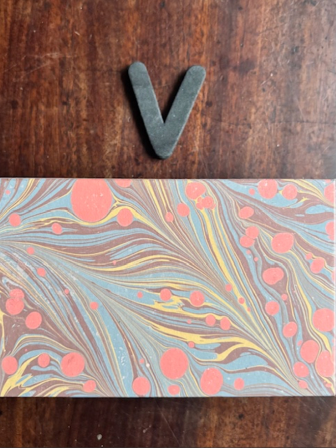 Matchbox Cover. A matchbox cover in V
