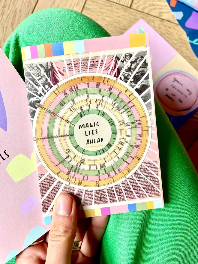 Brightly coloured card against bright green trousers