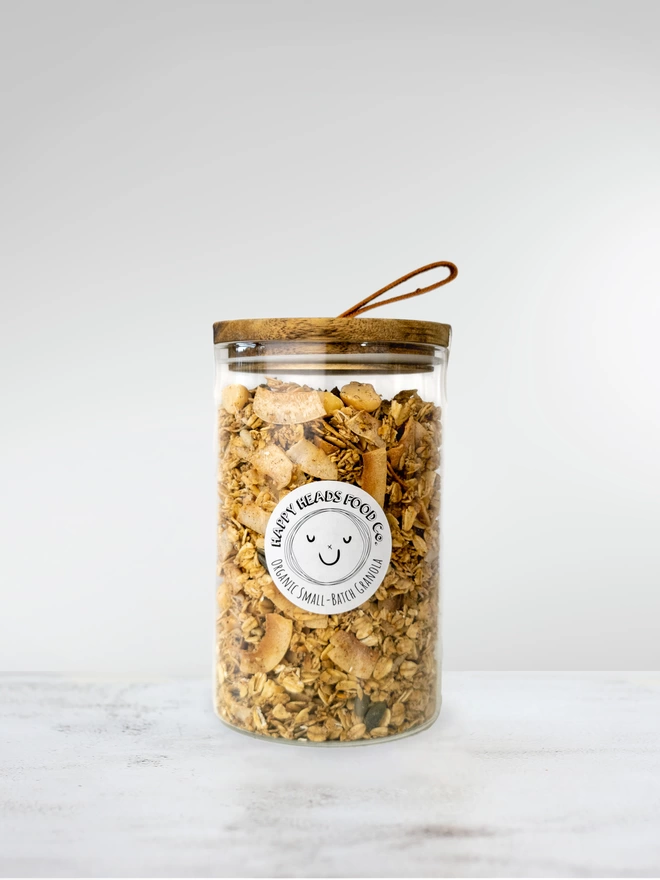 Happy Heads 'Cinnamon & Macadamia' granola in a medium (400 g) glass jar