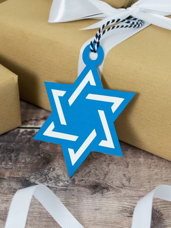Star of David Gift Tag attached to gift wrapped in brown paper
