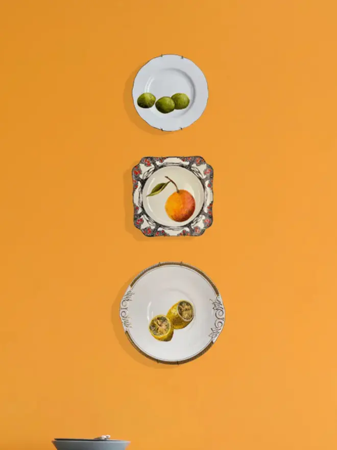 plate-scape. Fine Art Oil Painting Three Limes On A Vintage Plate, hanging  on an orange wall