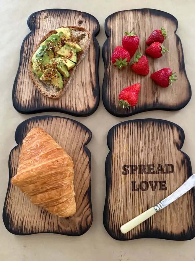 Toast shaped serving boards with toast avocado strawberries croissant and toast with engraved spread love and small vintage butter knife