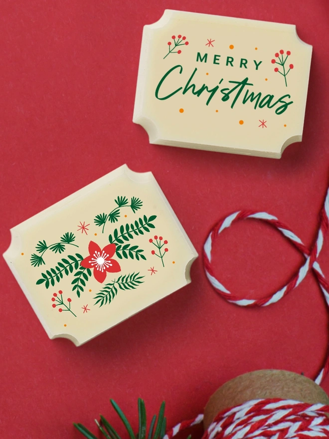 A pair of white chocolates with a Merry Christmas message