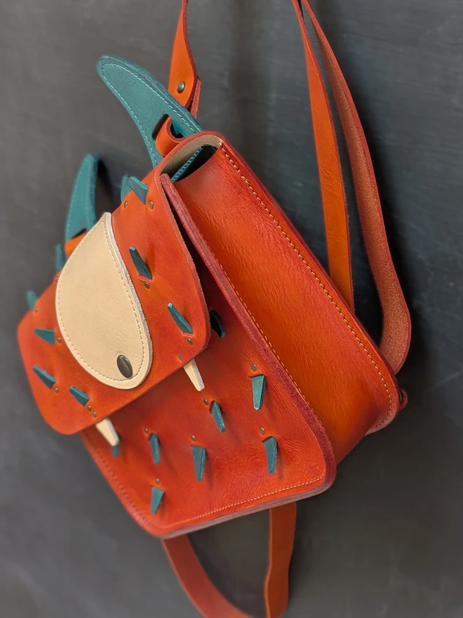 Leather monster backpack in orange and blue right side view