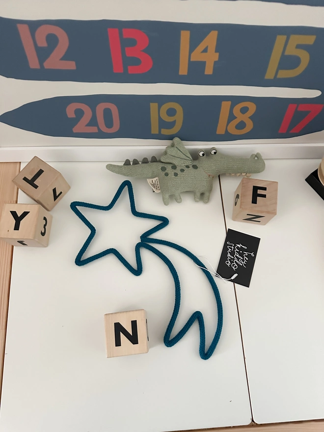 Shooting Star Wall Sign on an Ikea Wooden Table in a kid's play area or child's bedroom. 