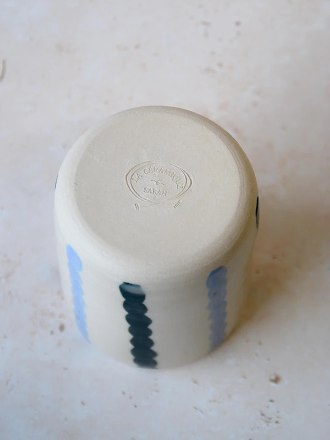 Handmade ceramic Stripe Pop tumbler — base view showing blue stripe and maker’s mark