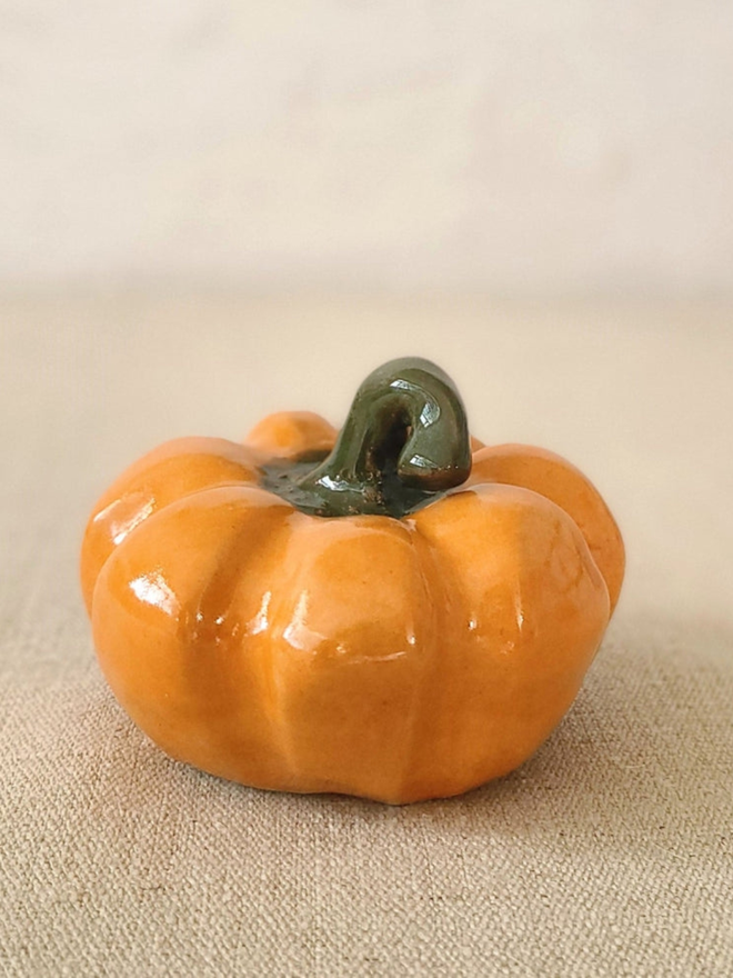 classic medium pumpkin. a painted orange ceramic pumpkin.