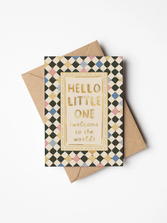 Hello little one, welcome to the world text in gold foil with checkerboard background