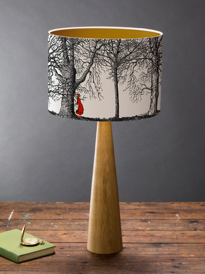Handmade drum lampshade featuring a whimsical Little Red Riding Hood inspired design with a red cape, big bad wolf, and dark woodland scene.