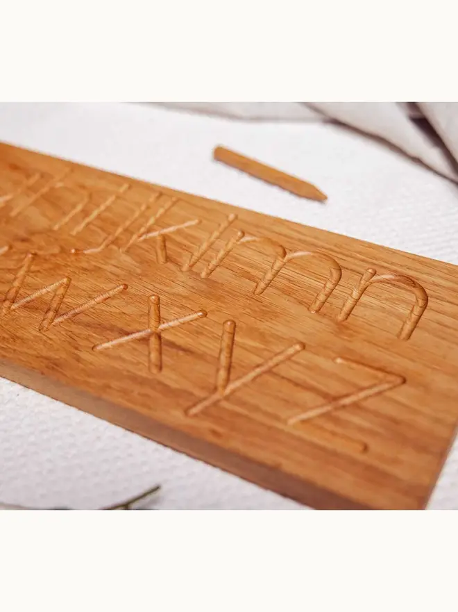 Wooden Alphabet Tracing Board Heirloom Toy, on a table. 