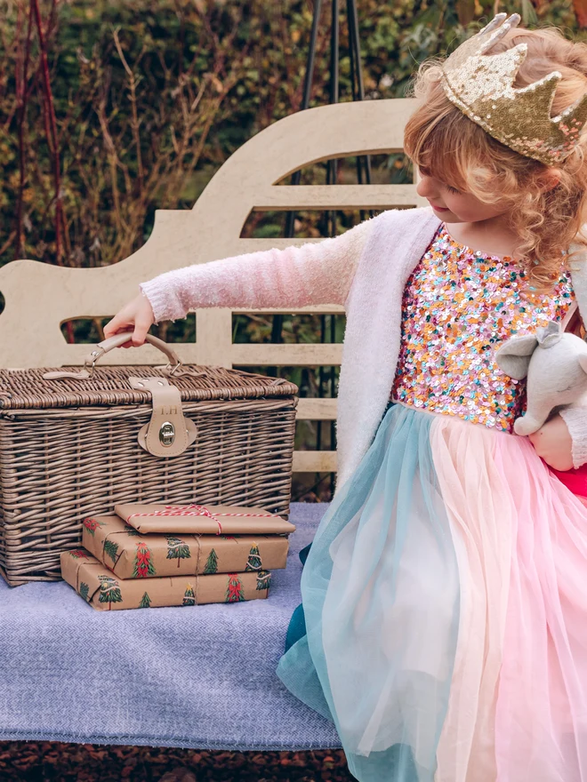 child with monogrammed wicker hamper basket