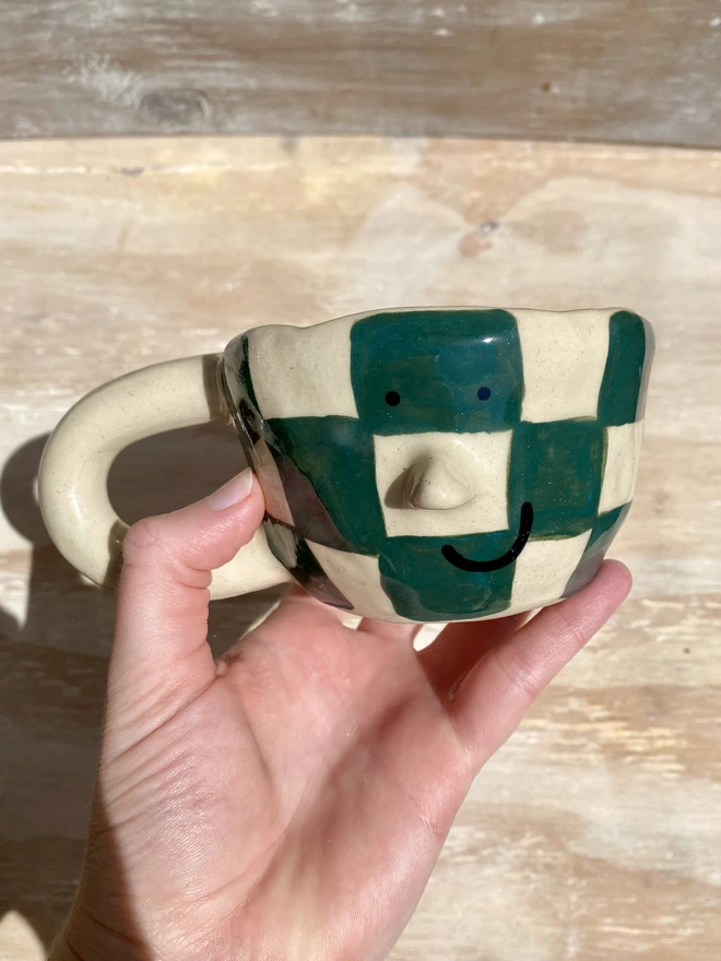 forest checkerboard mug - held