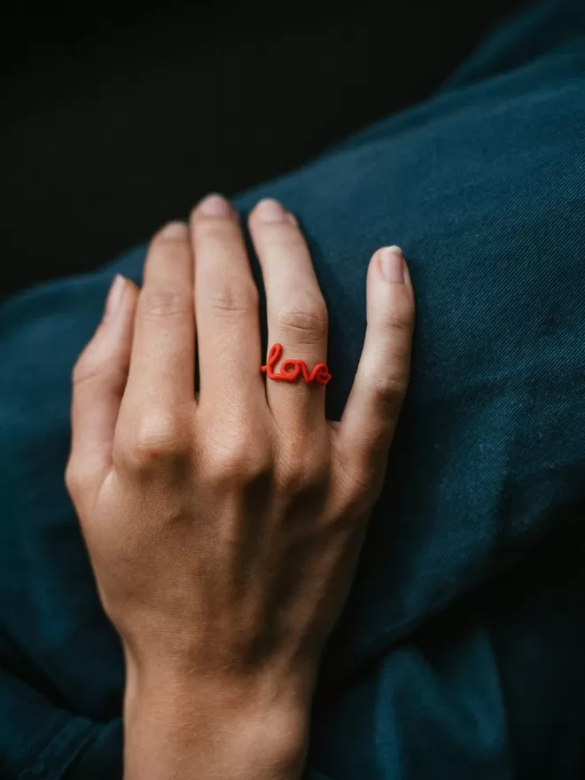 Zoe Sherwood Love Ring in red.